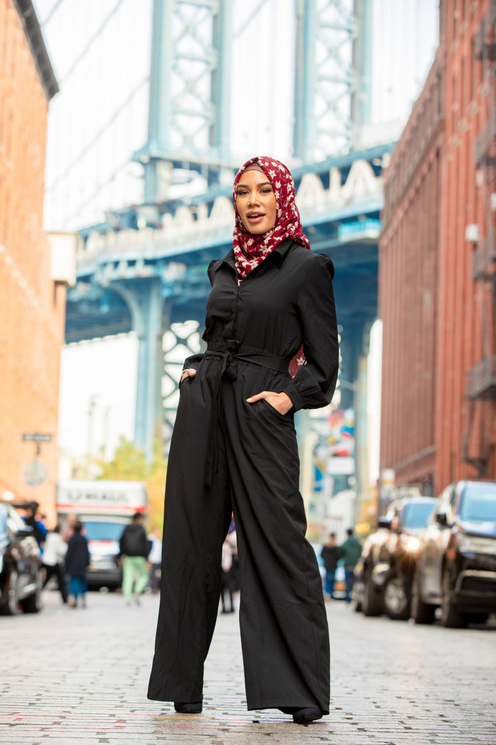 Stylish black jumpsuit paired with a floral hijab for a chic look on clearance