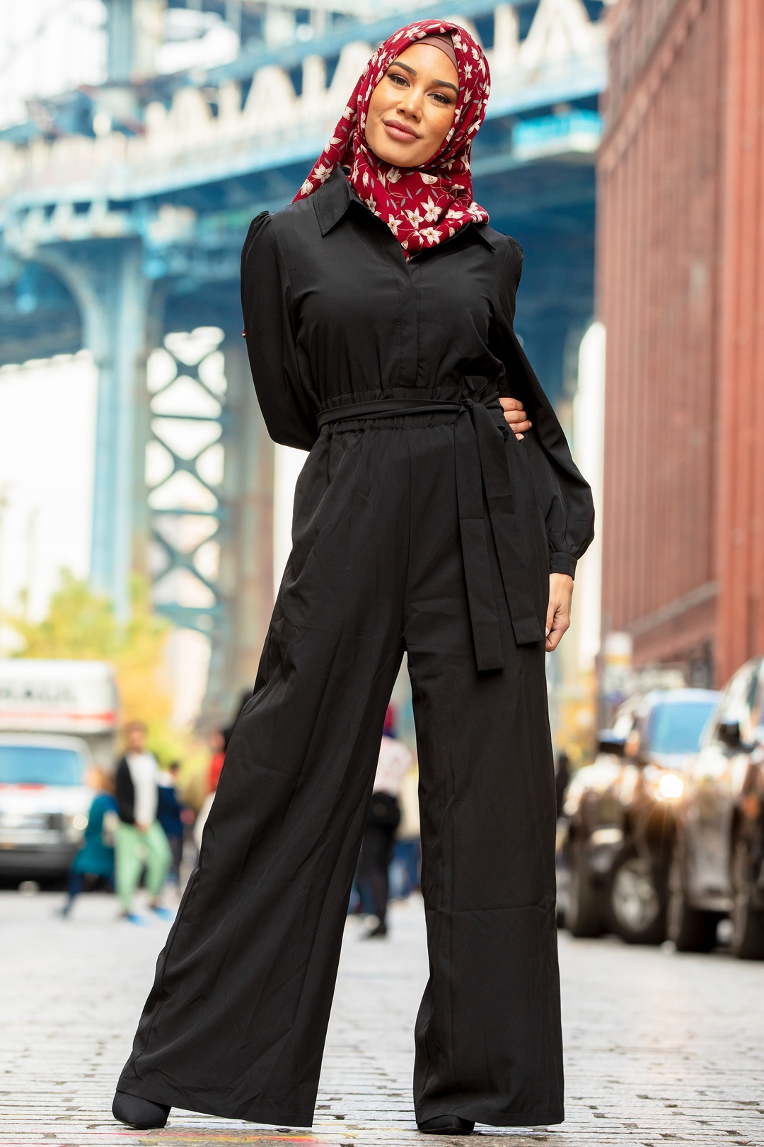 Black belted jumpsuit paired with a floral hijab, perfect for stylish occasions