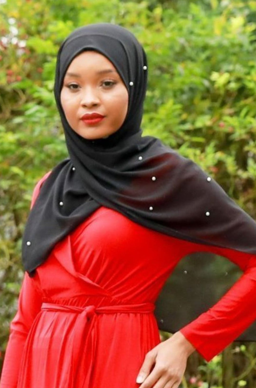 Woman in red dress wearing Black Pearl Chiffon Hijab for elegant style