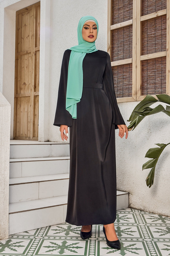 Elegant black satin maxi dress with kimono sleeves paired with a mint green hijab