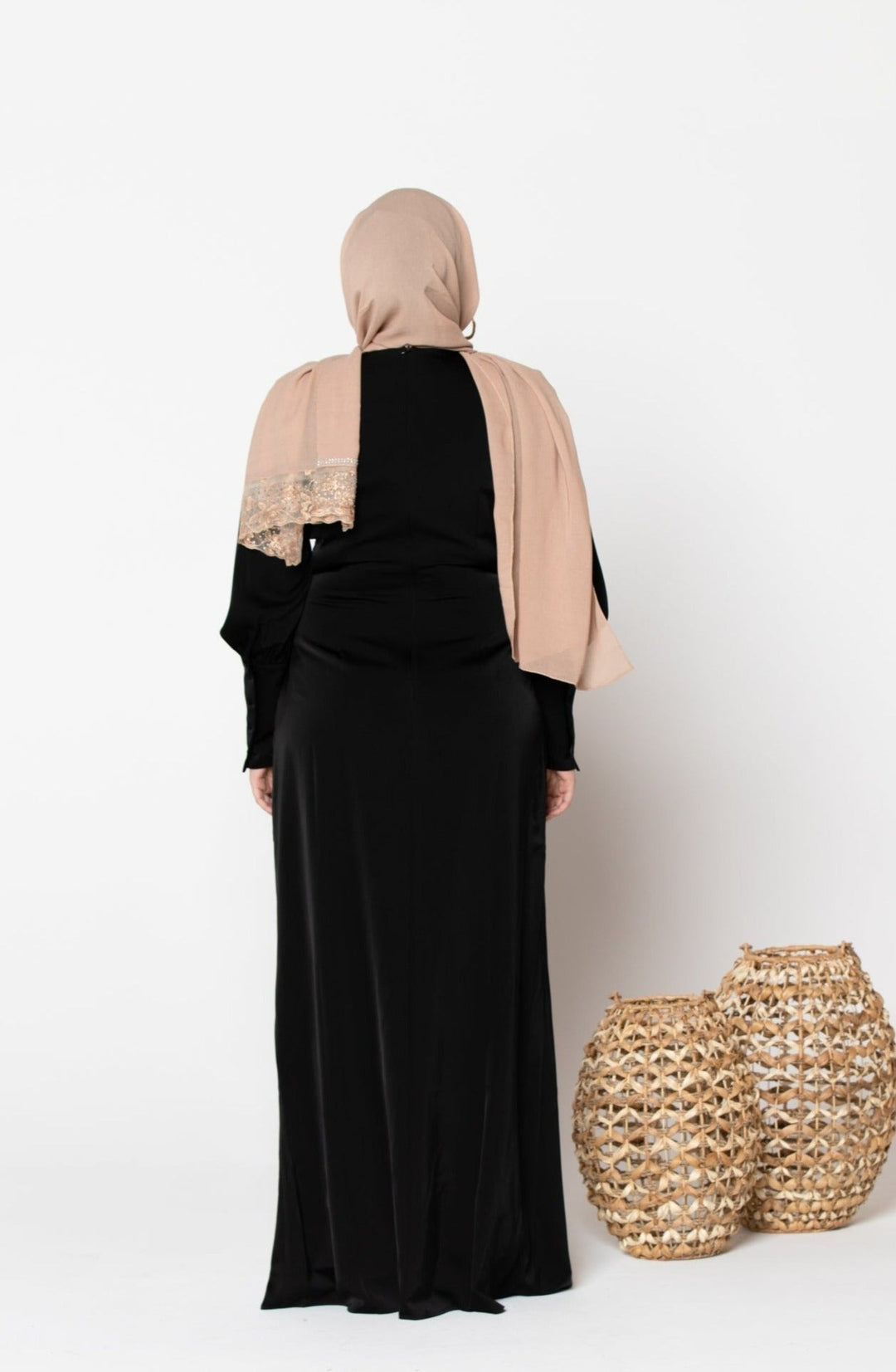 Woman in black dress and beige hijab wearing a satin long sleeve maxi dress