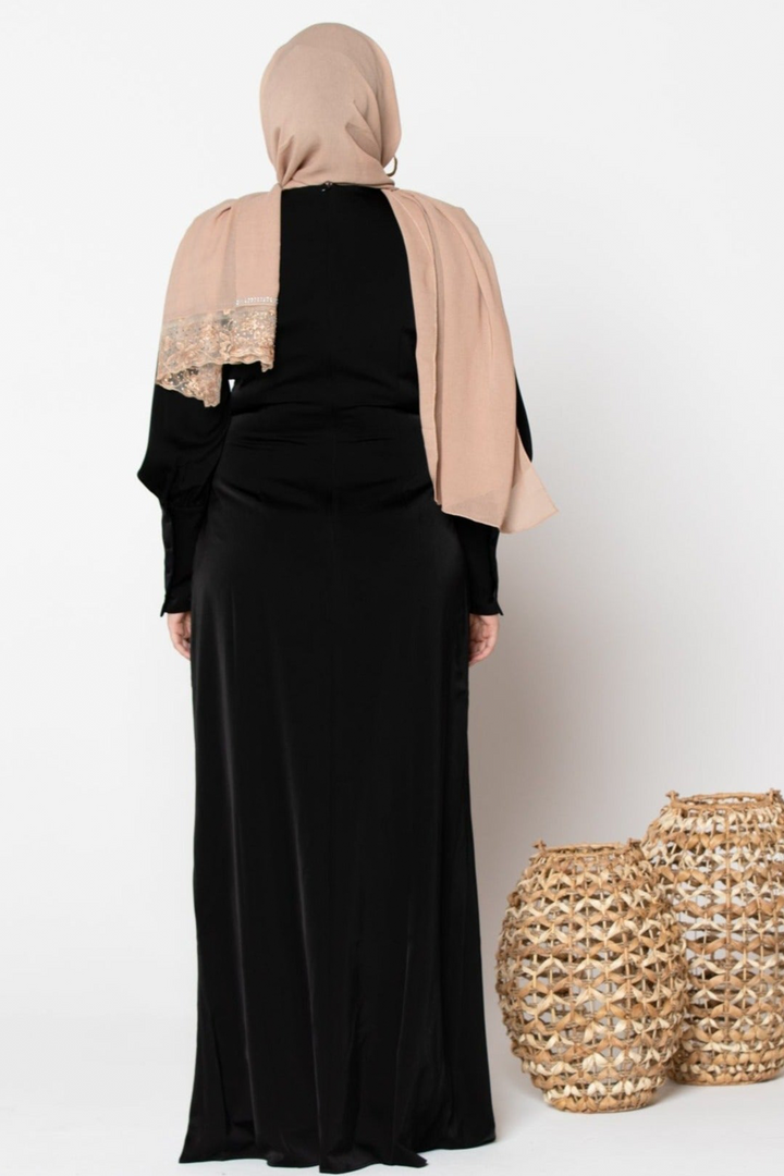 Woman in black dress and beige hijab wearing a Black Satin Long Sleeve Maxi Dress