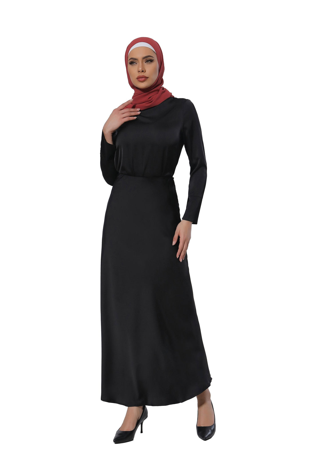 Woman in a black satin long sleeve skirt set with a red hijab, showcasing elegance