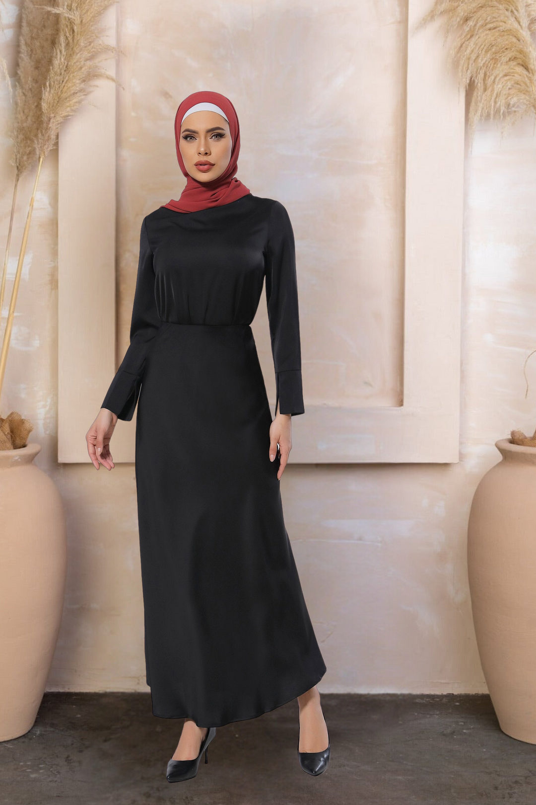 Woman in a long-sleeved black satin long sleeve skirt set with a red hijab