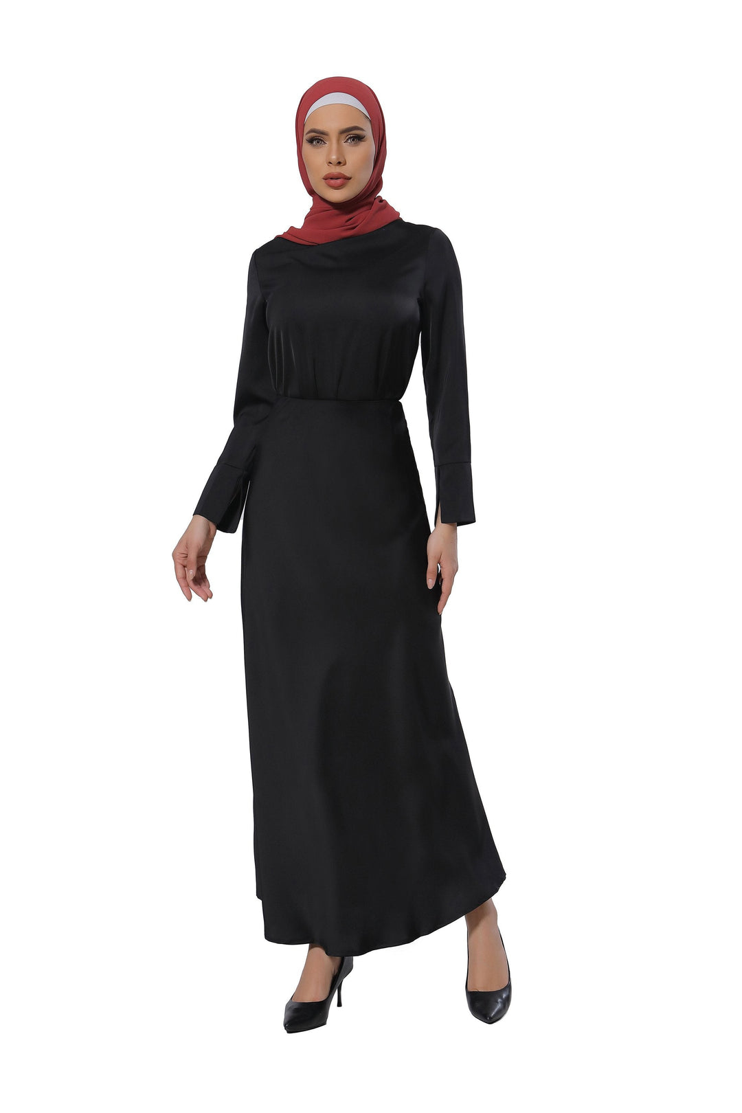 Woman in a long-sleeved black dress and red hijab wearing a satin long sleeve skirt set