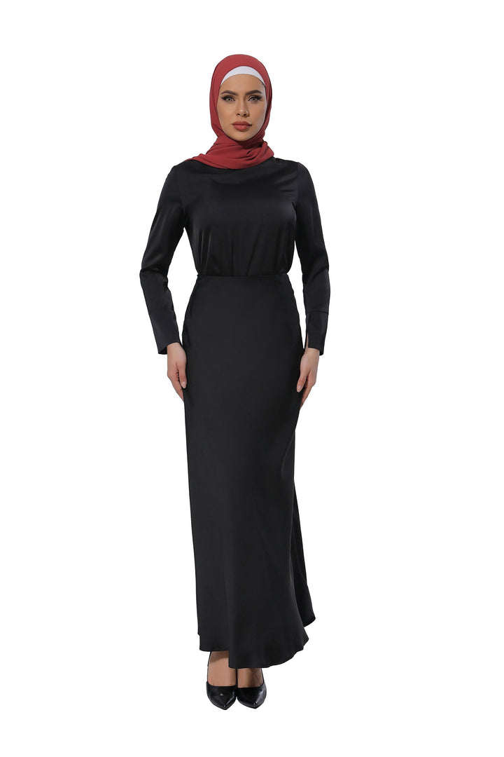 Woman in long black satin long sleeve skirt set with a red hijab