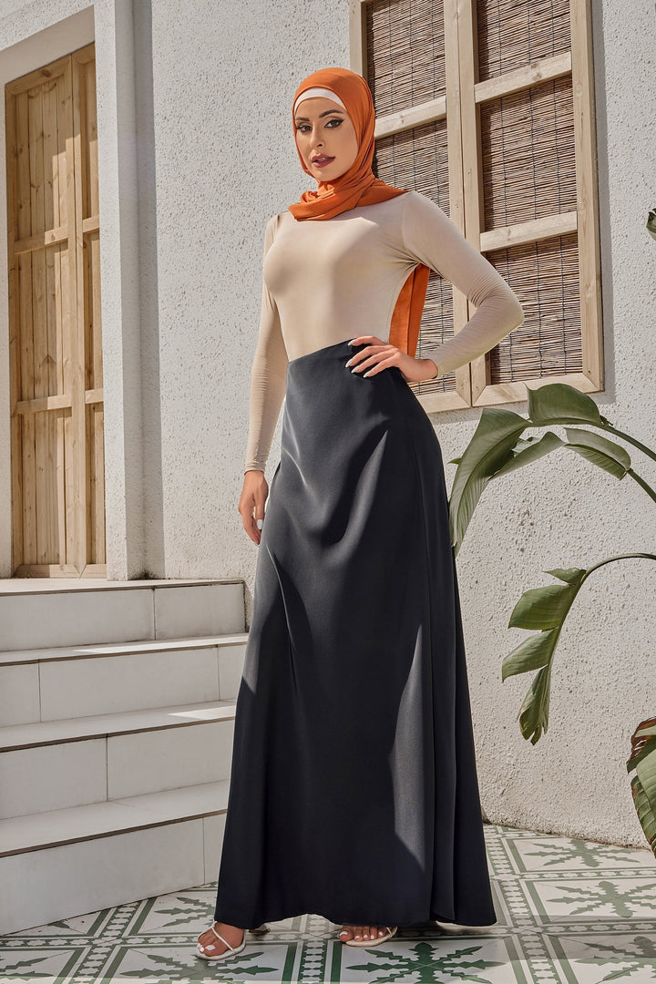 Woman in hijab wearing a long-sleeved top with a Black Satin Maxi Skirt