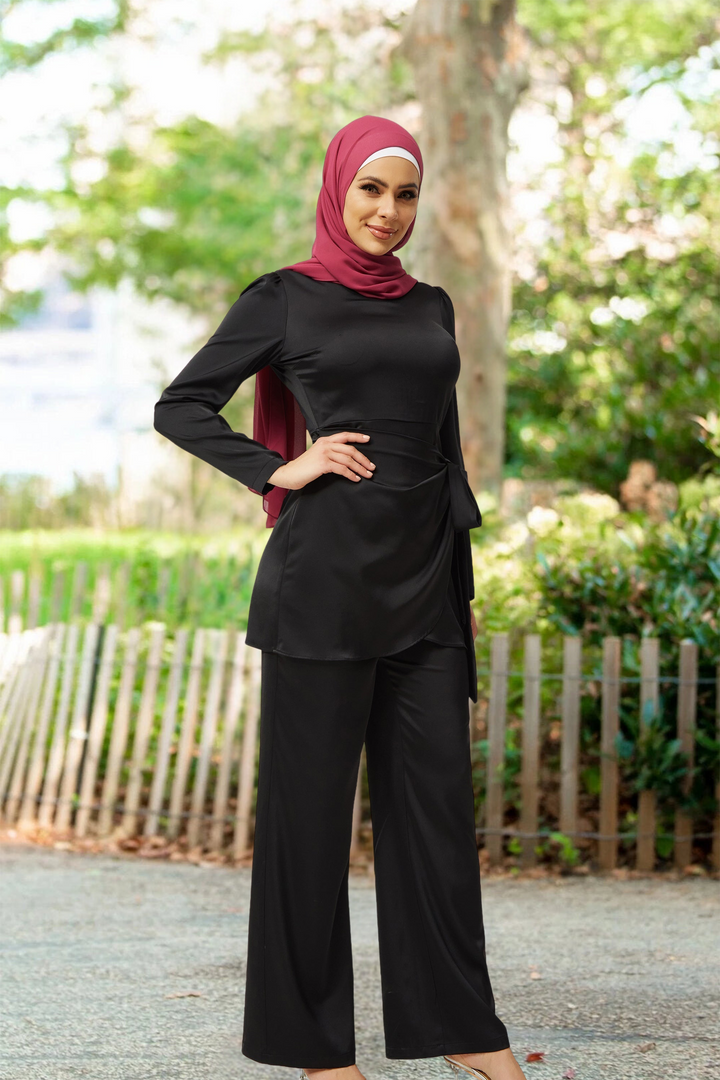 Woman in black modest fashion wearing Black Satin Side Wrap Tunic & Pant Set