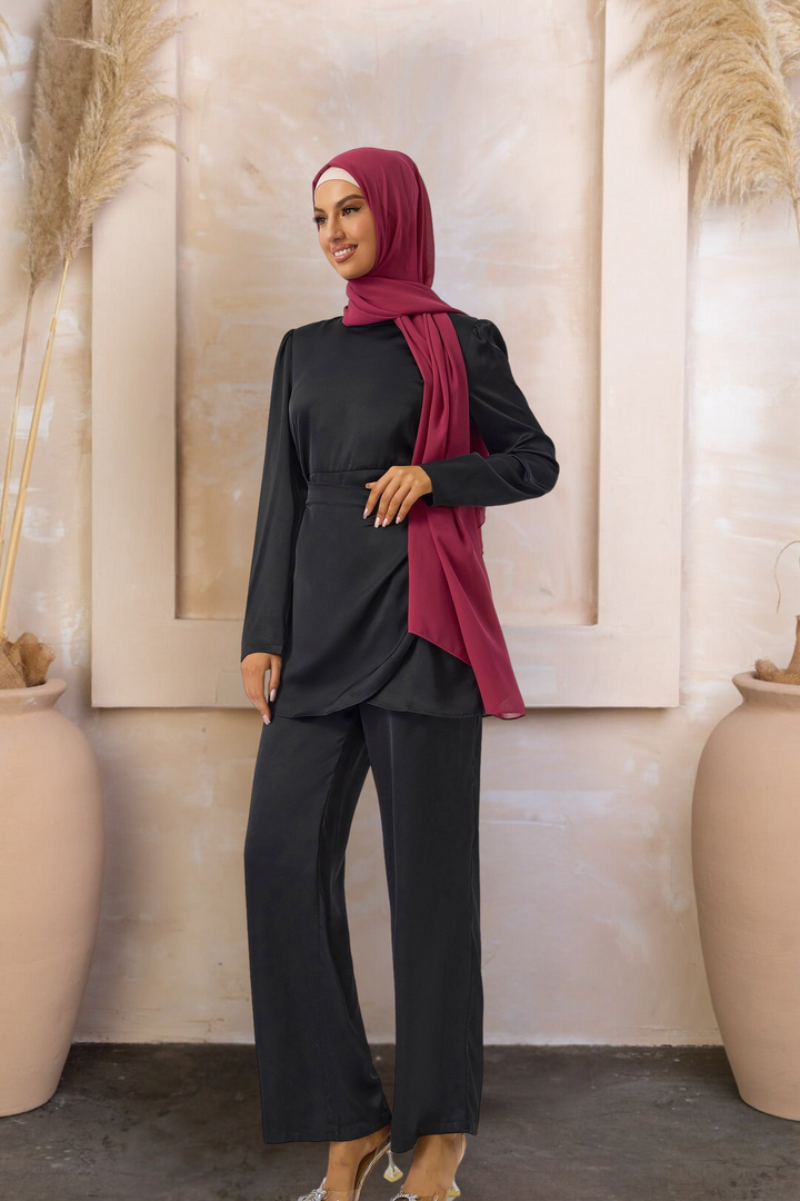 Woman in black wrap tunic and pants set with maroon hijab showcasing stylish outfit