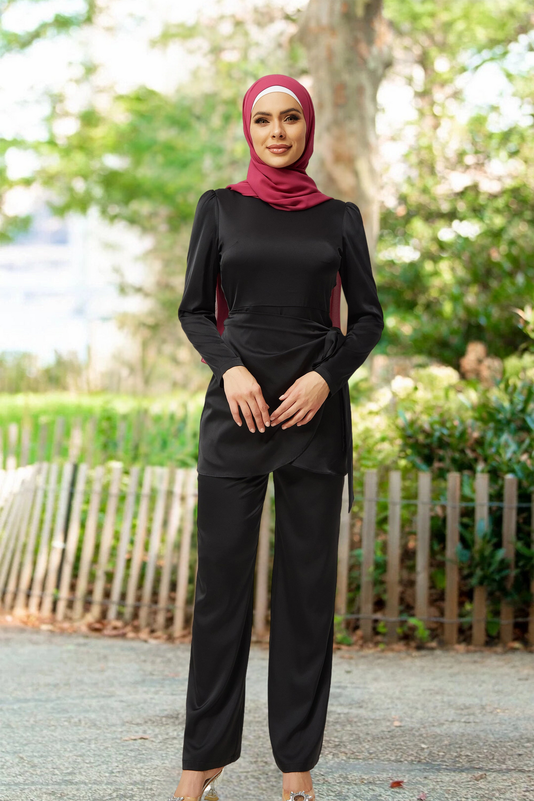 Woman in black modest fashion wearing a Black Satin Side Wrap Tunic & Pant Set