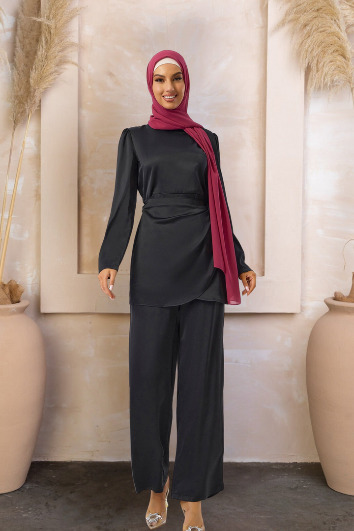 Woman in black satin pant set and maroon hijab showcasing wrap tunic style