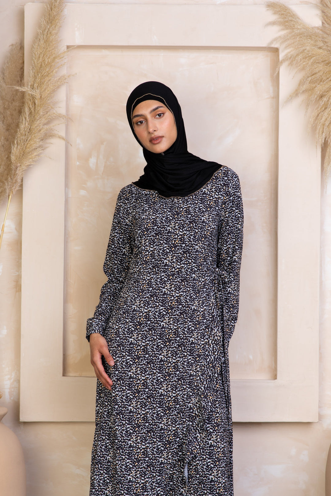 Long-sleeved patterned dress with hijab, featuring a yellow ruffle wrap dress style