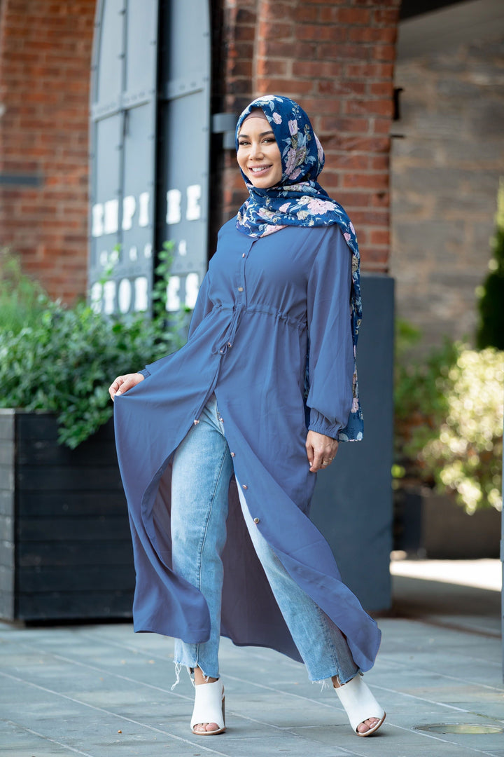 Woman in blue tunic and hijab wearing a Blue Button Down Drawstring Maxi Cardigan