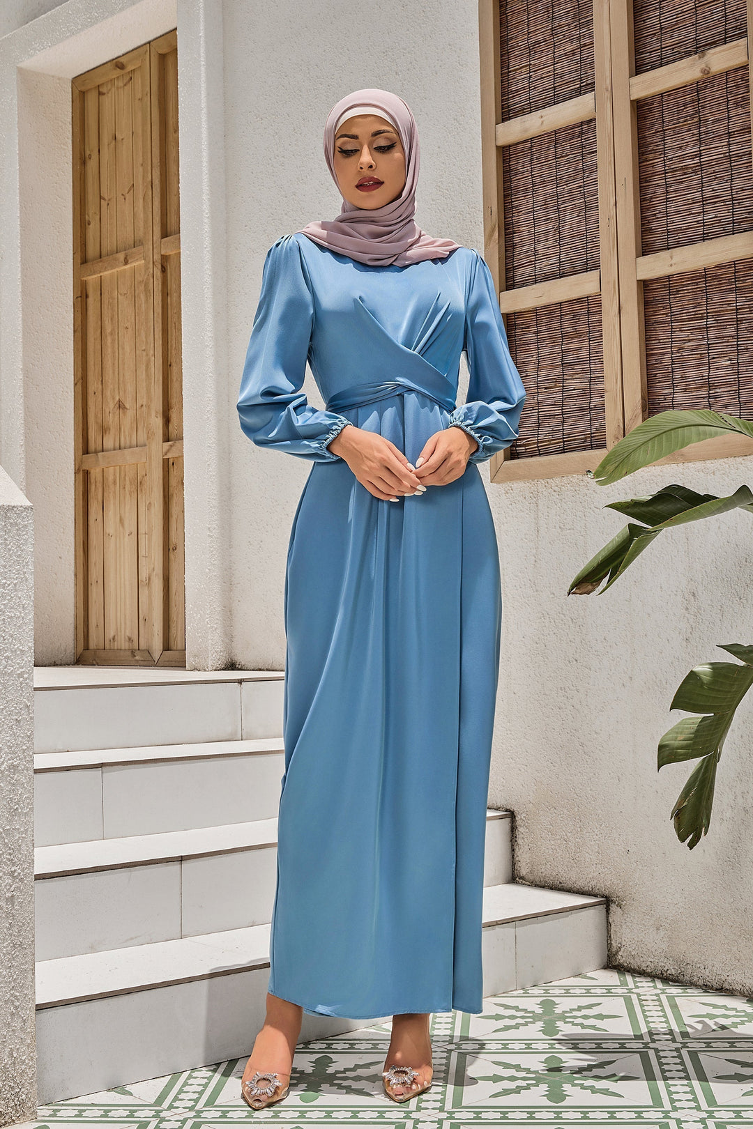 Woman in a blue criss cross satin faux wrap maxi dress and hijab on clearance