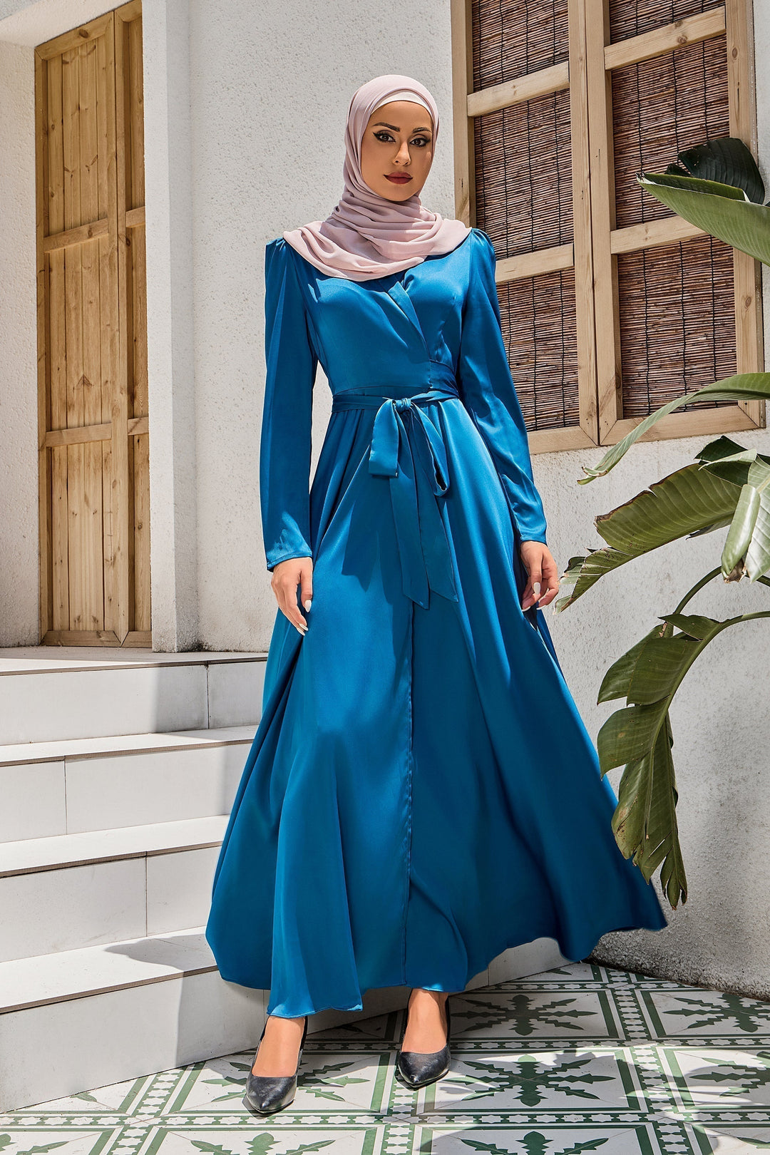 Woman in blue criss cross tie maxi dress with hijab on clearance display