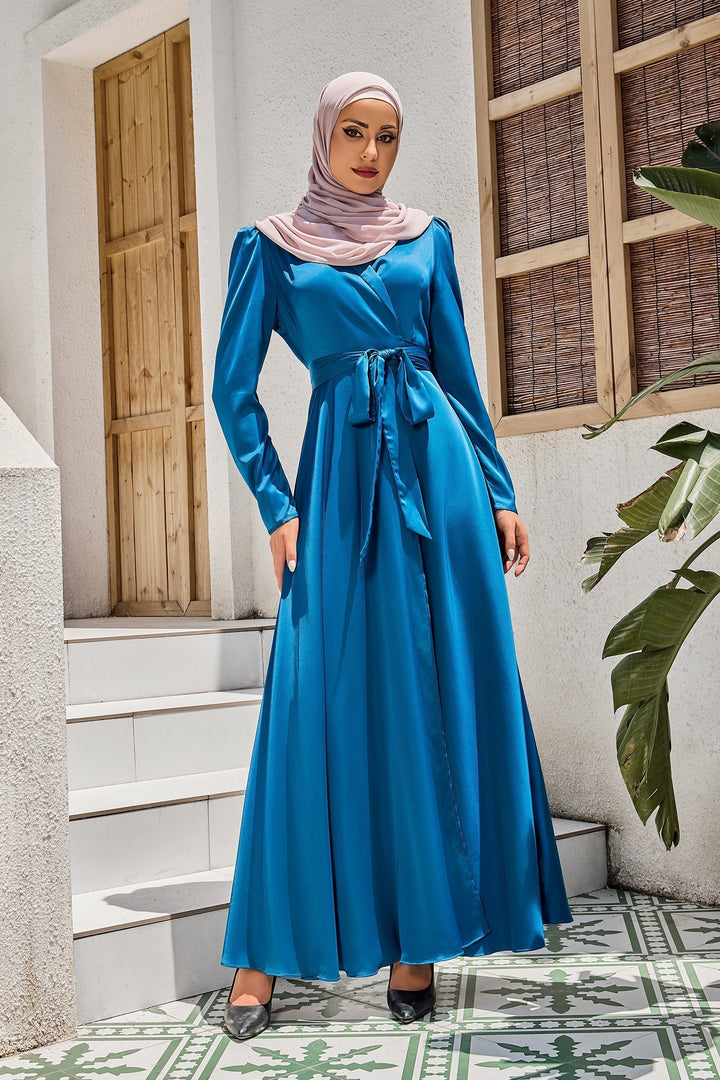 Woman in a blue satin criss cross wrap tie maxi dress with hijab displayed for clearance