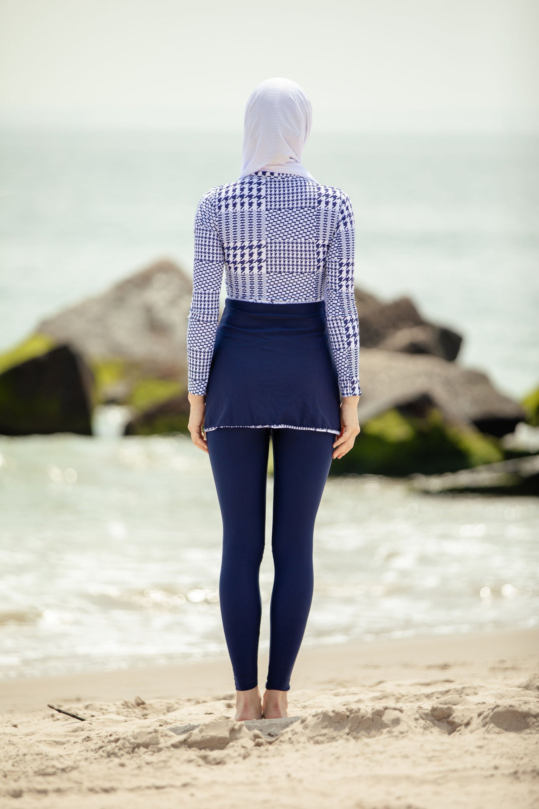 Modest swimwear featuring a blue houndstooth print top and navy skirted leggings