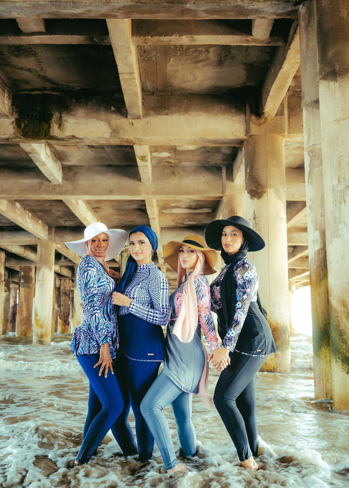 Four women in blue houndstooth print modest swimwear showcasing a stylish look