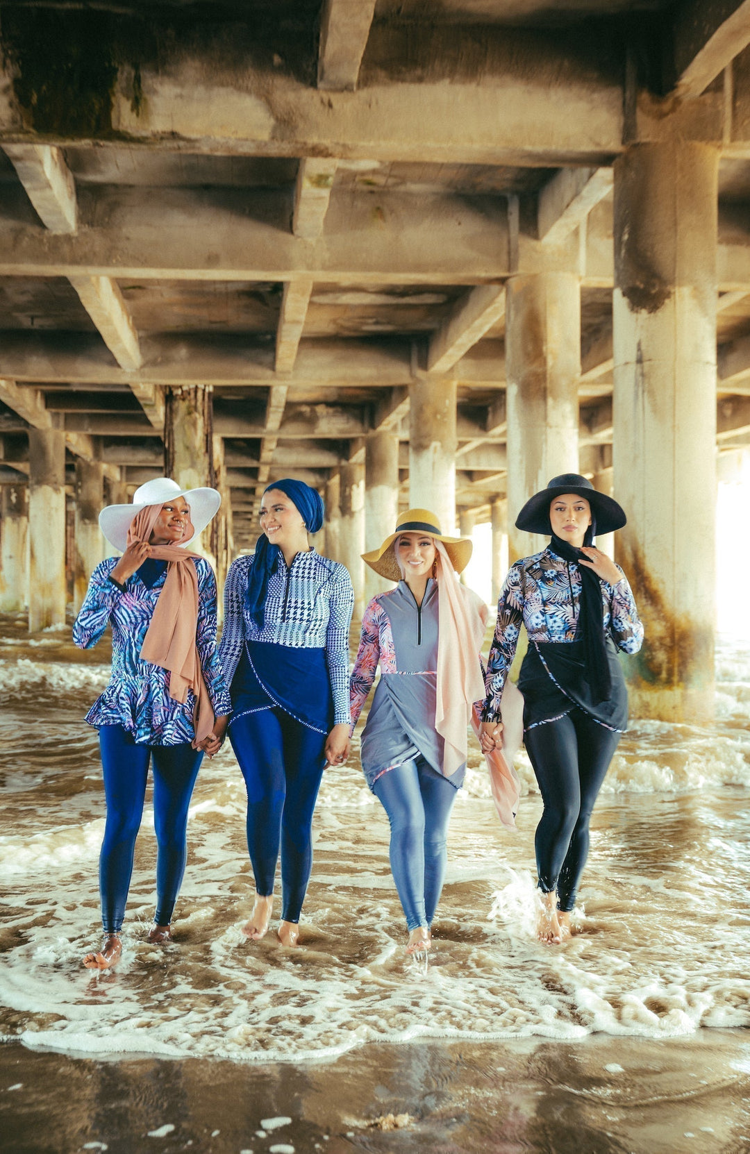 Four women in blue houndstooth print modest swimwear showcasing a stylish look