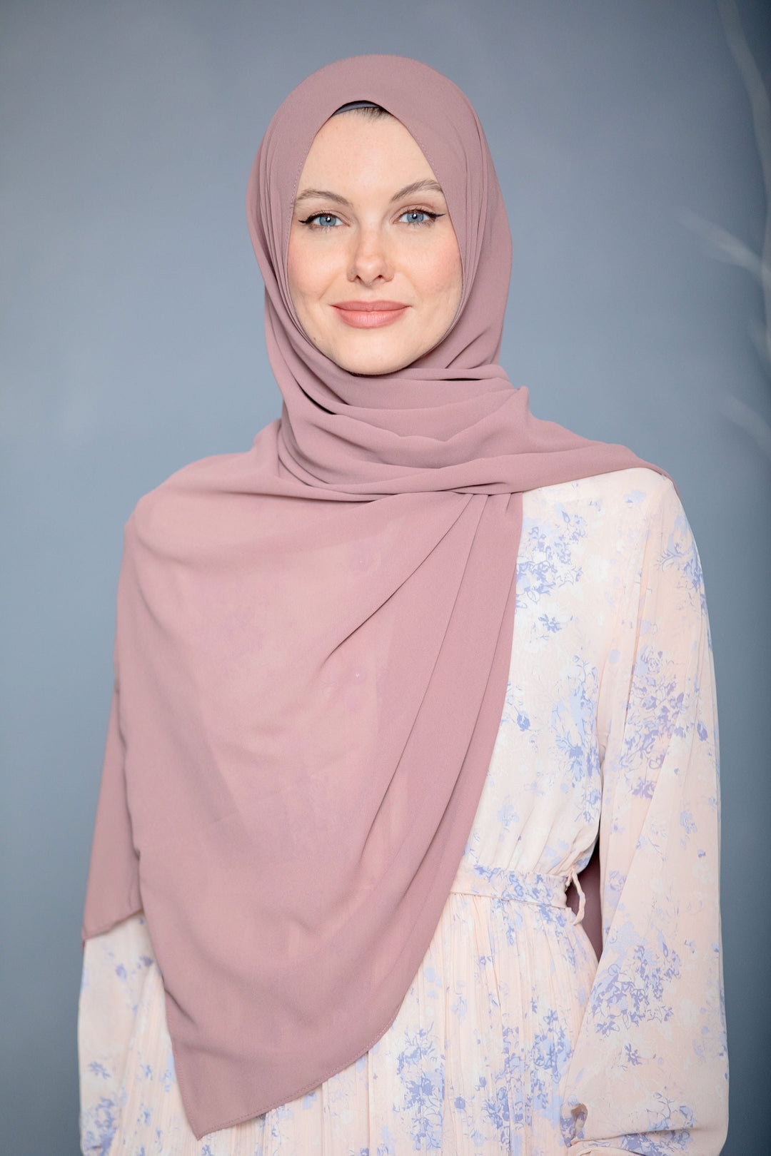 Woman wearing a mauve chiffon scarf from the Blush Pink Chiffon Hijab collection