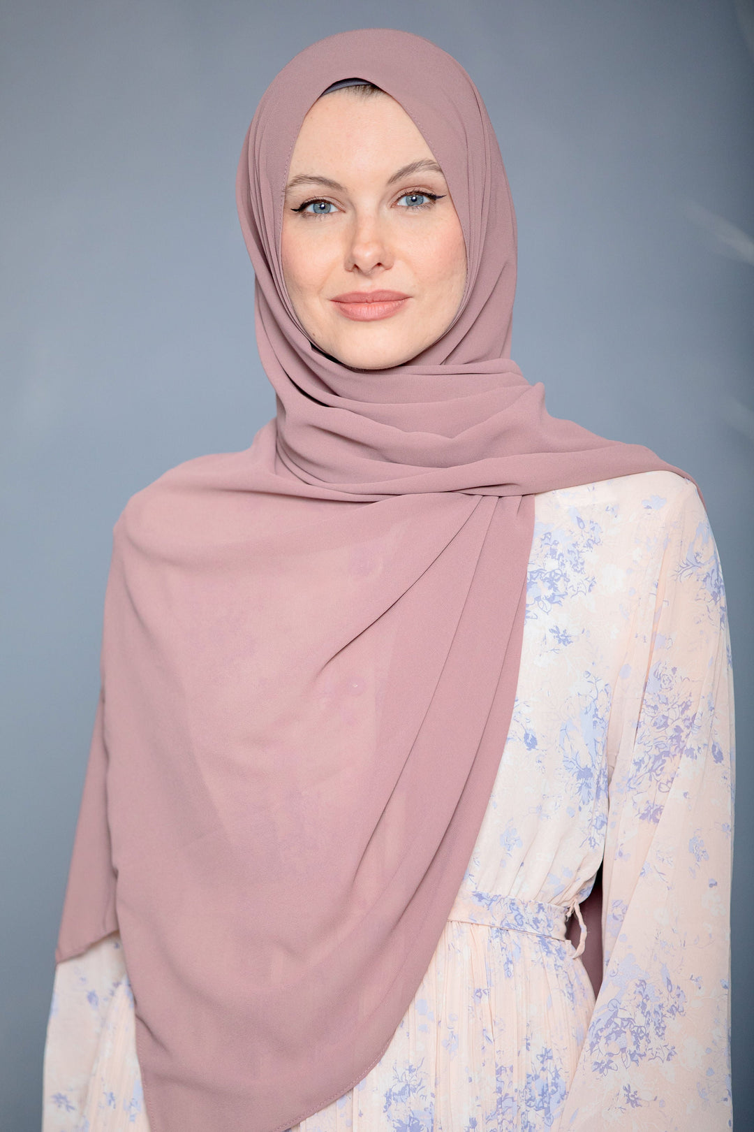 Woman wearing a mauve chiffon hijab, perfect as a stylish scarf accessory