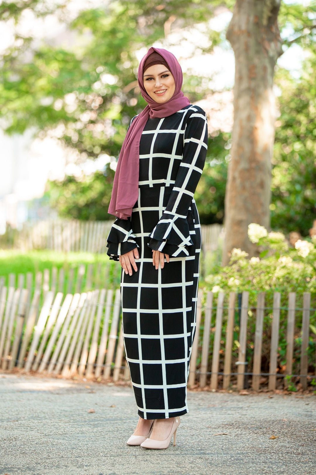 Black and white grid-patterned dress with mauve chiffon hijab and brown criss-cross underscarf