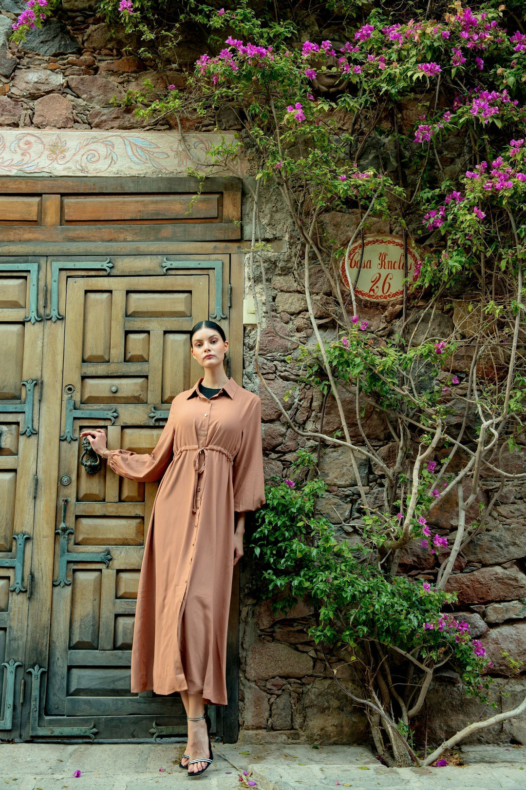 Tan button-down dress showcased in a Brown Button Down Drawstring Maxi Cardigan