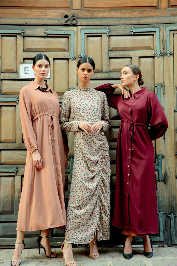 Three women showcasing the Brown Button Down Drawstring Maxi Cardigan style