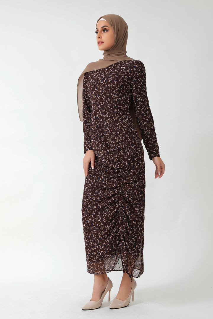 Woman in brown floral ruched maxi dress with adjustable ruching and fully lined design