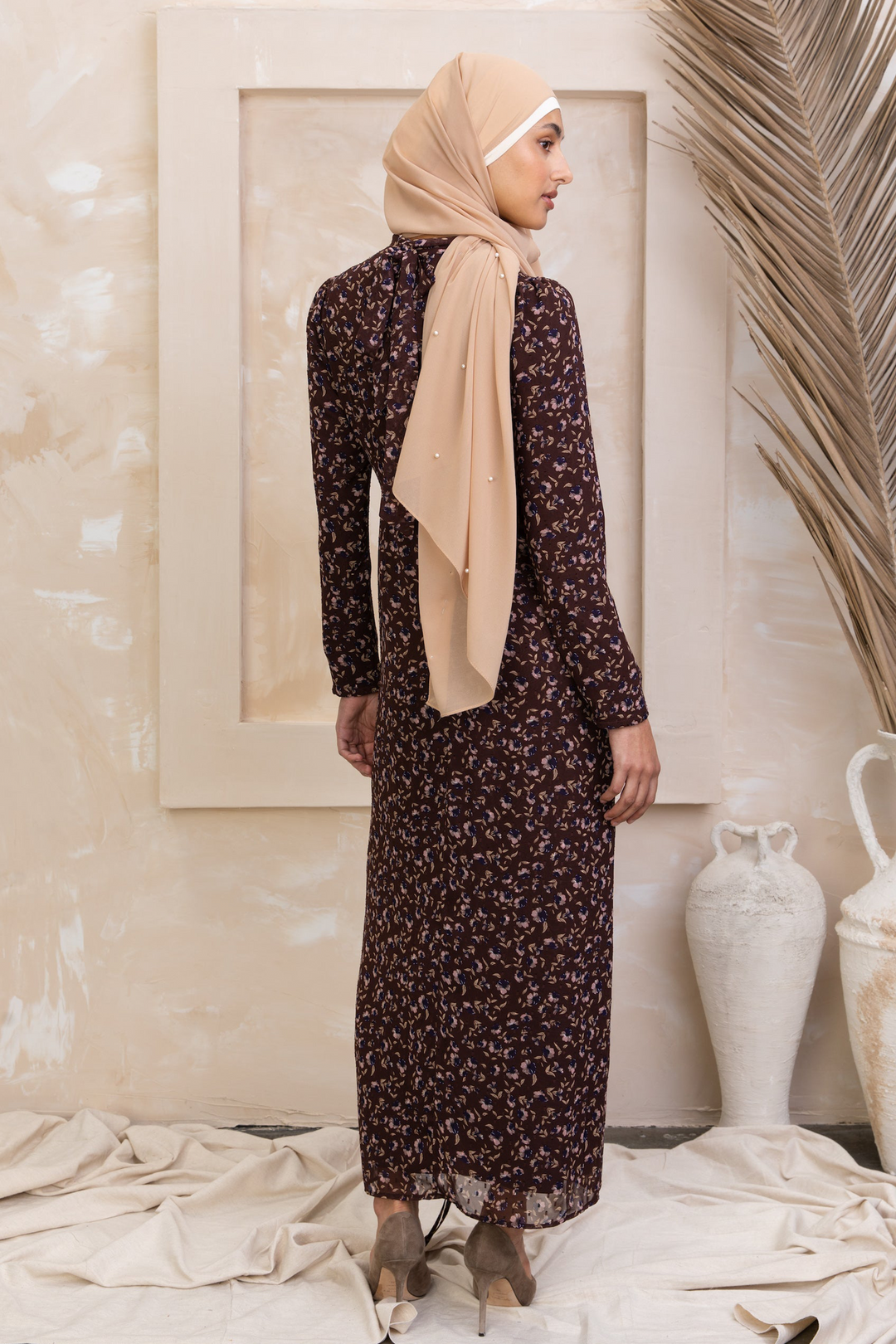 Woman wearing a Brown Floral Ruched Maxi Dress showcasing adjustable ruching and full lining