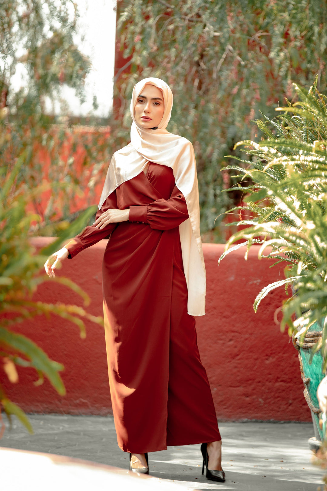 Woman in maroon dress and cream hijab wearing a Brown Wrap Maxi Dress with criss cross neckline