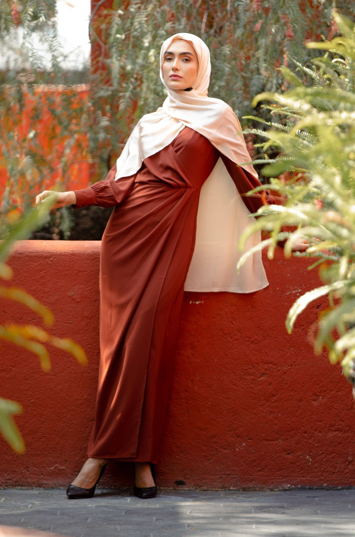 Woman wearing a Brown Wrap Maxi Dress with a criss cross neckline and cream hijab