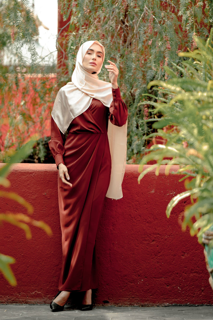 Burgundy satin dress with hijab featuring a criss cross neckline and wrap skirt