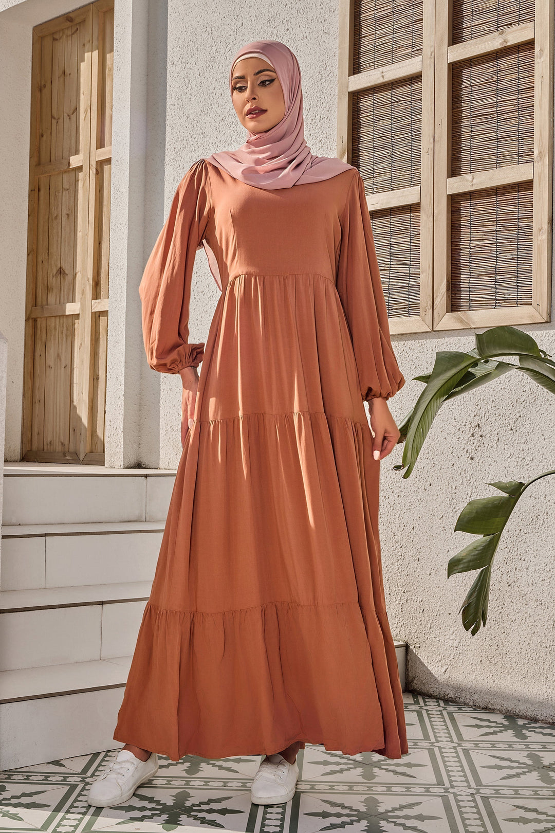 Burnt orange long sleeve maxi dress with tiered design and matching hijab for modest style