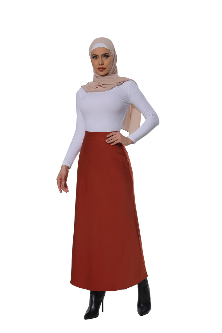 Woman in a modest satin skirt showcasing the Burnt Orange Satin Skirt style