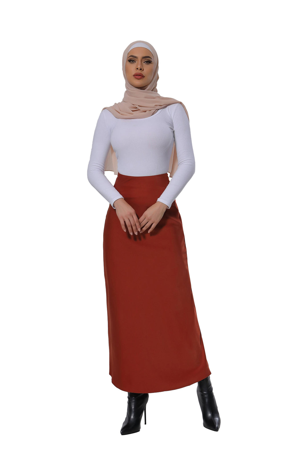 Woman in hijab styling a Burnt Orange Satin Skirt with boots for a chic look