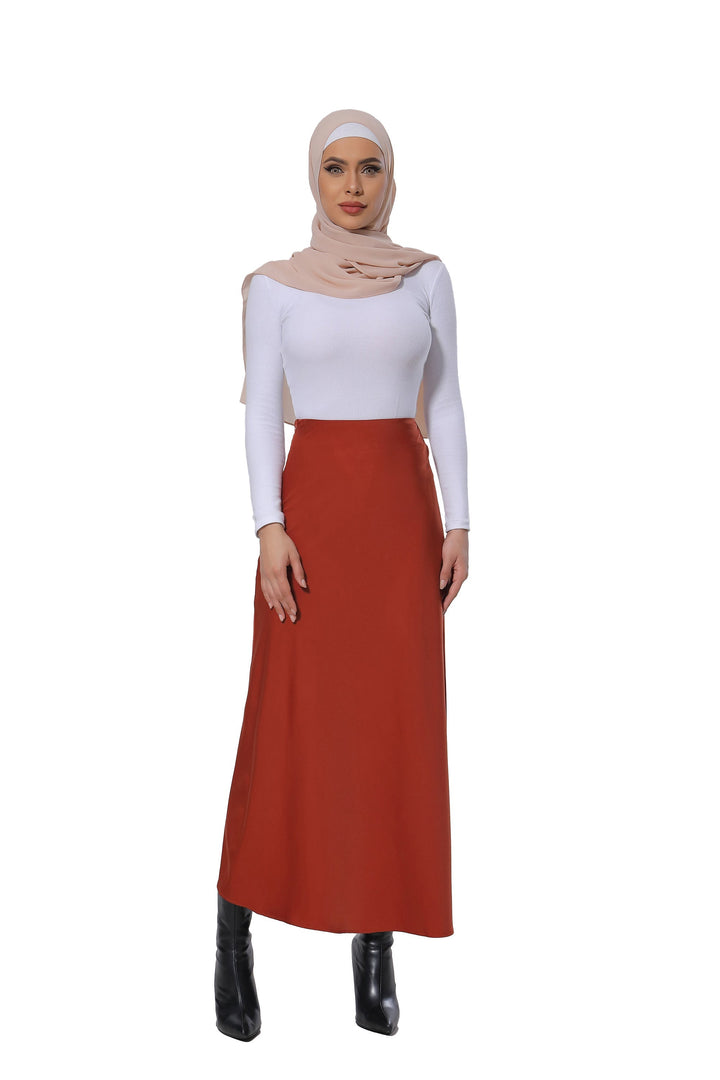 Woman in hijab wearing a Burnt Orange Satin Skirt styled as a maxi skirt