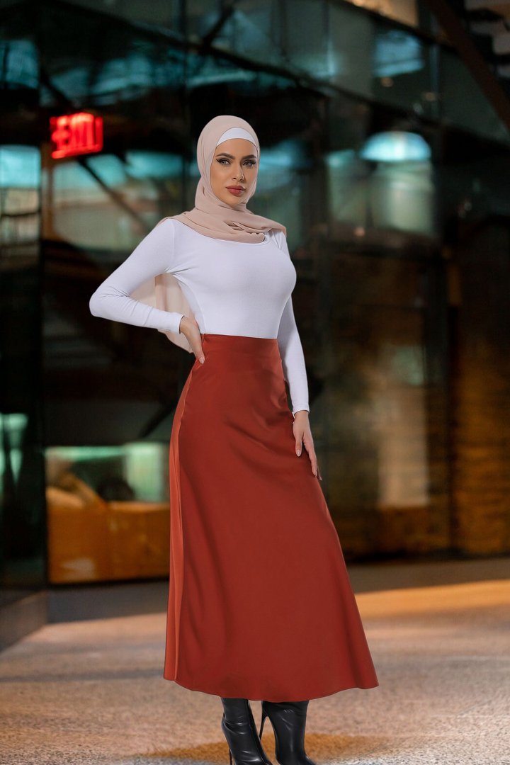 Woman in modest fashion wearing a Burnt Orange Satin Skirt styled as a maxi skirt