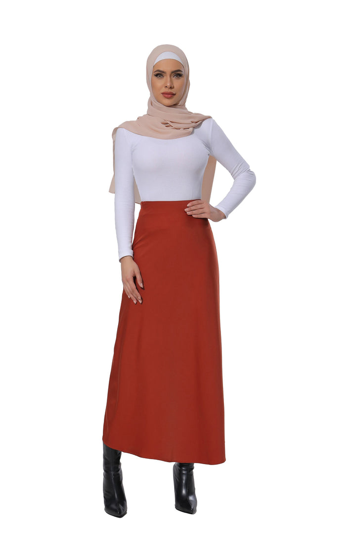 Woman in modest attire wearing a Burnt Orange Satin Skirt perfect for maxi dress outfits