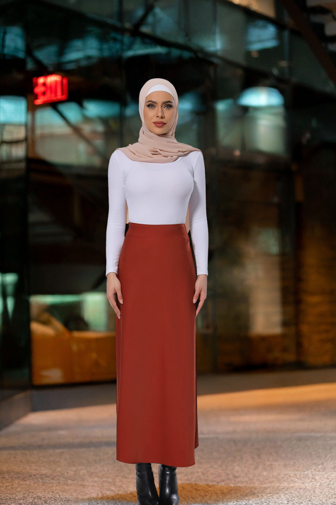 Woman in a hijab wearing a Burnt Orange Satin Skirt with a long-sleeved shirt