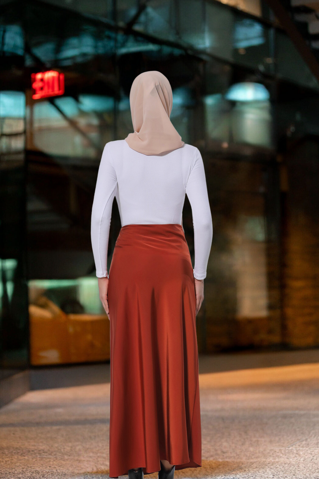 Woman in hijab wearing a stylish Burnt Orange Satin Skirt with a white top