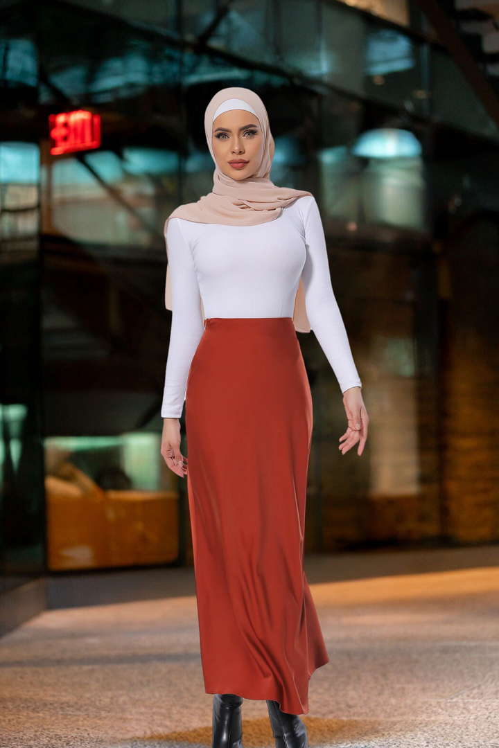 Woman modeling a Burnt Orange Satin Skirt as part of a stylish modest fashion outfit