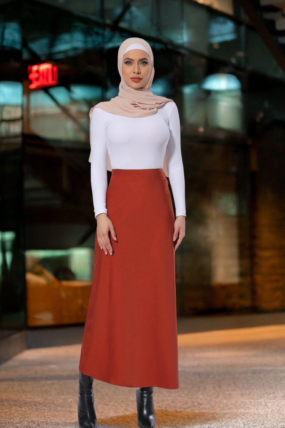 Woman in hijab showcasing a Burnt Orange Satin Skirt styled with a white top