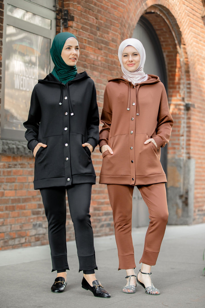 Two women in stylish hooded button-down tracksuit pants set for clearance sale