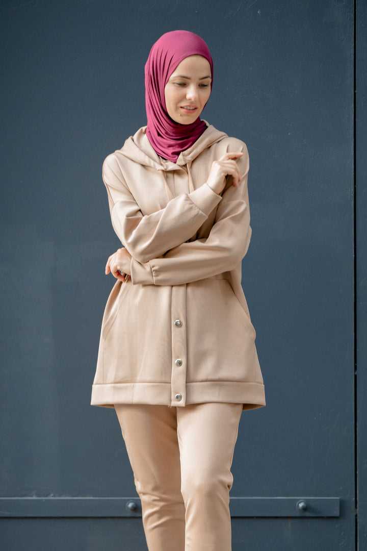 Woman in hijab wearing beige hoodie sweatshirt and pants set on clearance sale