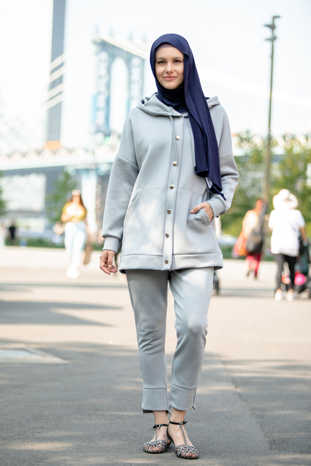 Woman in gray hoodie sweatshirt and pants set with navy hijab for stylish comfort