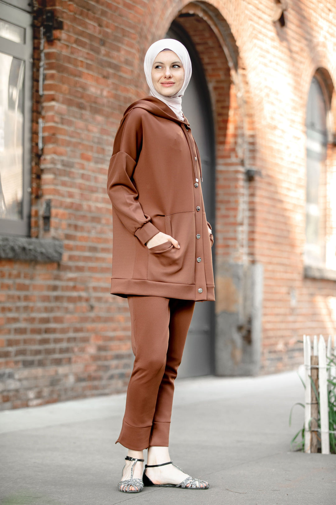 Woman wearing brown hooded tracksuit from Button Down Hoodie Sweatshirt and Pants Set