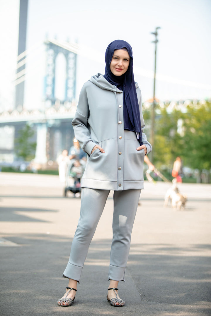 Woman in gray tracksuit with navy hijab wearing hoodie sweatshirt and pants set