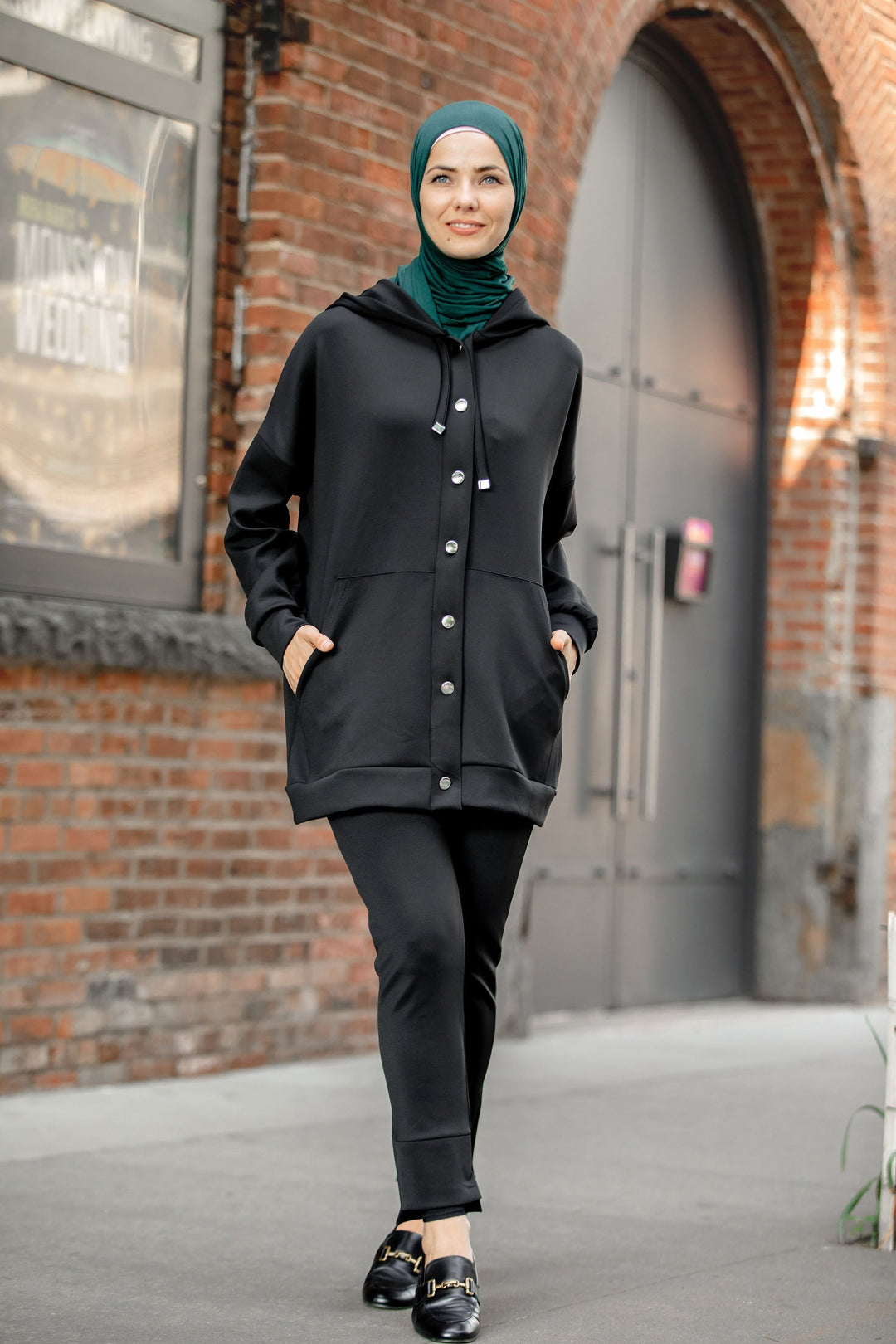 Woman in black button down hoodie sweatshirt and pants set for clearance sale