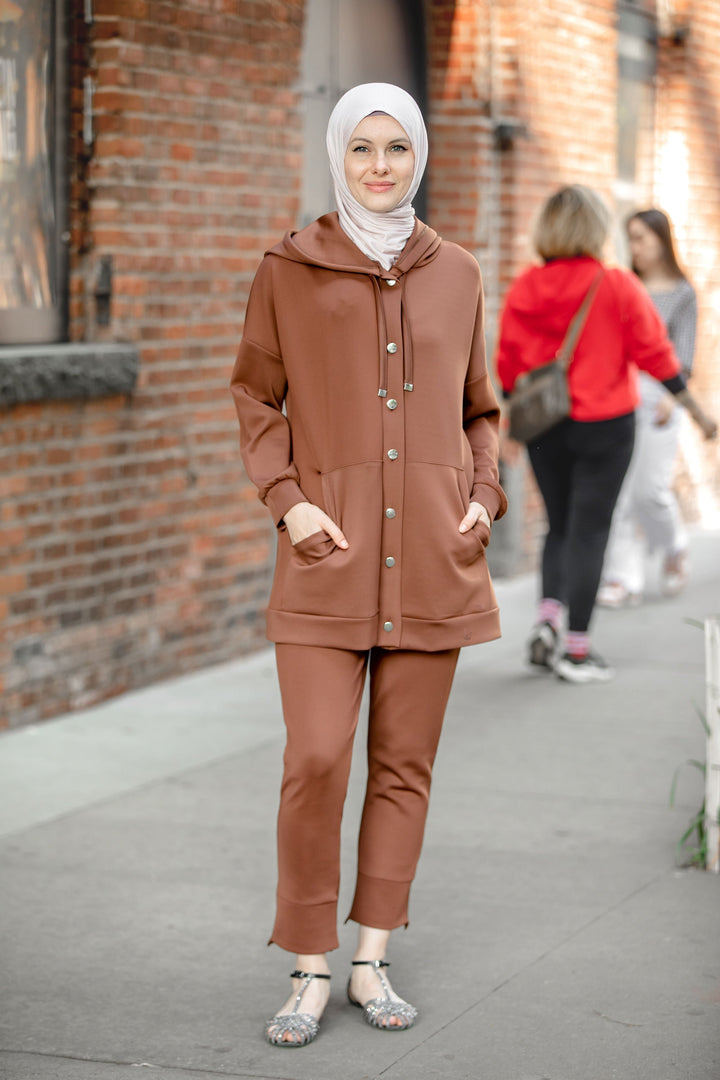 Woman in brown hoodie sweatshirt and pants set showcasing stylish modest fashion